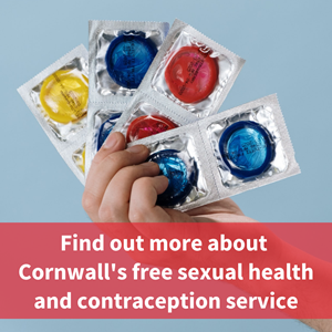 Image of hand holding packs of condoms, text reads "find out more about cornwalls free sexual health and contraception service"