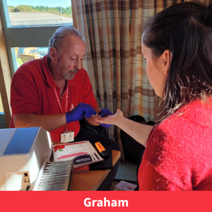 A member of healthy cornwall team smiling whilst performing a health check, text reads "Graham"