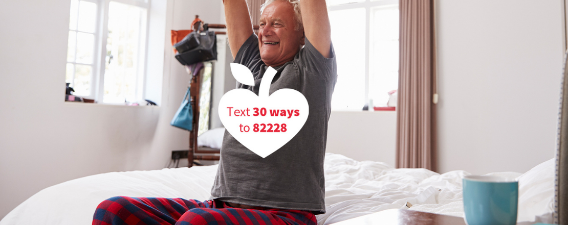 Man stretching upwards on bed, text reads 'Text 30 ways to 82228'