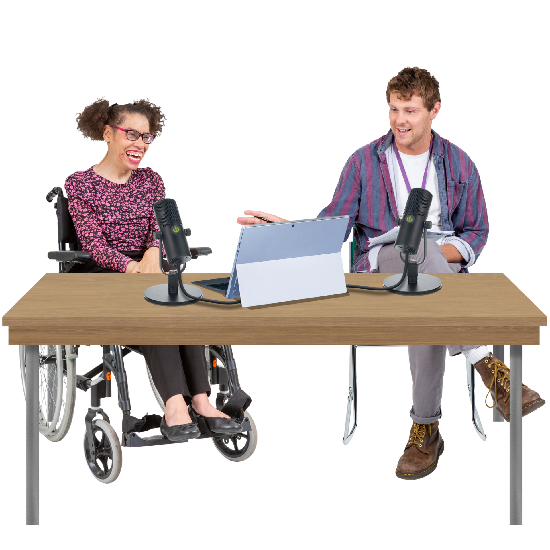 two people sat behind a desk recording a podcast